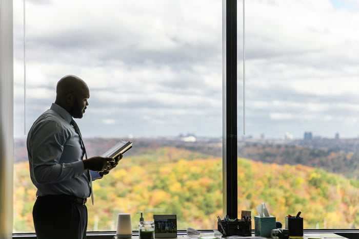Man looking at a record book while standing