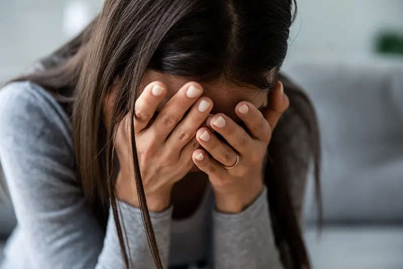 Upset millennial girl crying, suffering from consequences of wrong decision, depression concept.